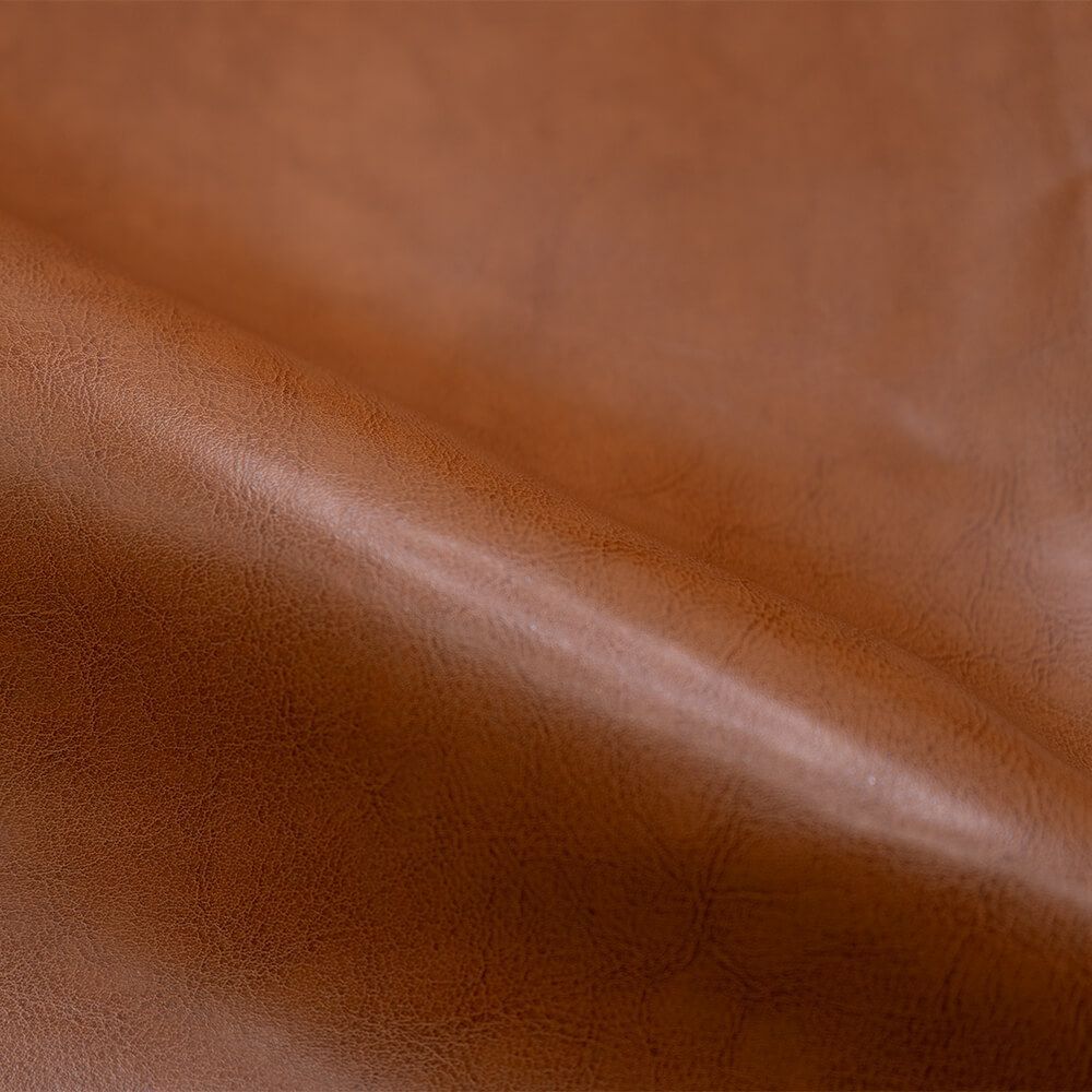 zoom matiere fauteuil club cuir camel marron